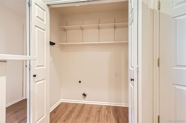 washroom with wood finished floors, electric dryer hookup, and baseboards