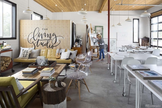 misc room featuring concrete flooring and wooden ceiling