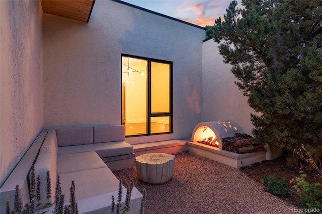 patio terrace at dusk featuring a fire pit