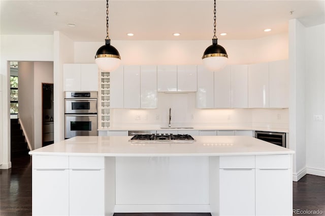 kitchen featuring hanging light fixtures, white cabinets, and a kitchen island