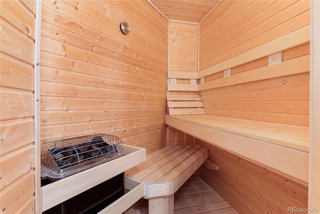 view of sauna / steam room with wood walls and wood-type flooring