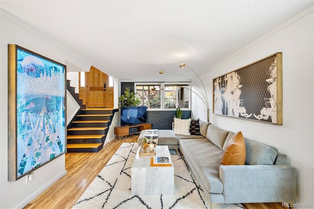 living room with stairway and wood finished floors