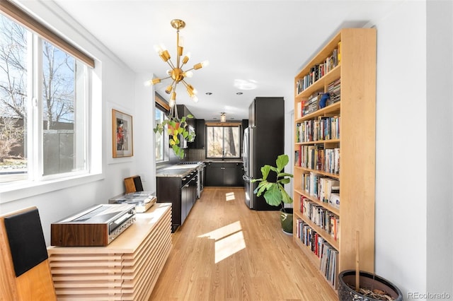 interior space featuring light wood-style floors and an inviting chandelier