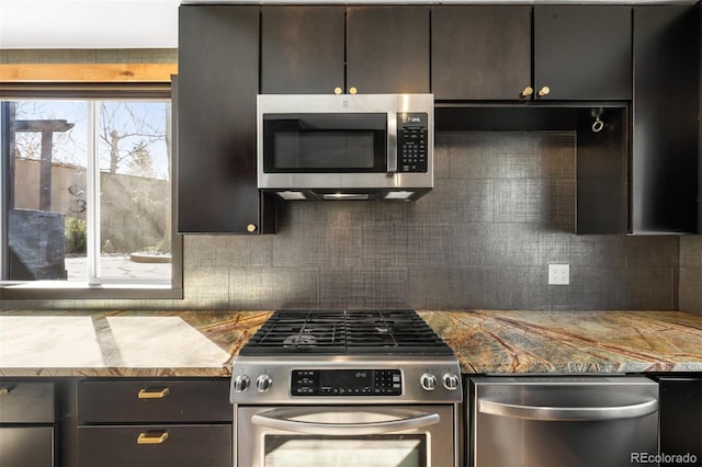 kitchen featuring stainless steel appliances and tasteful backsplash