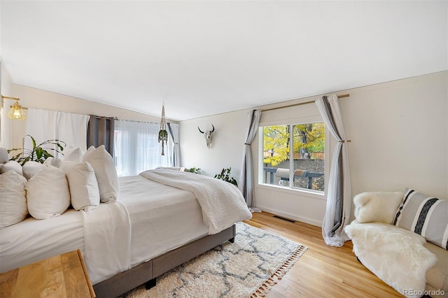 bedroom featuring light wood-style flooring and visible vents