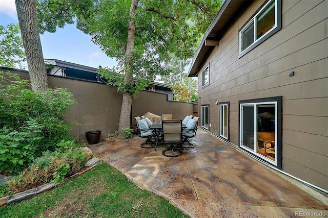 view of patio with fence and outdoor dining space