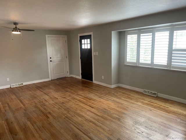 entrance foyer featuring light hardwood / wood-style floors, a textured ceiling, and ceiling fan