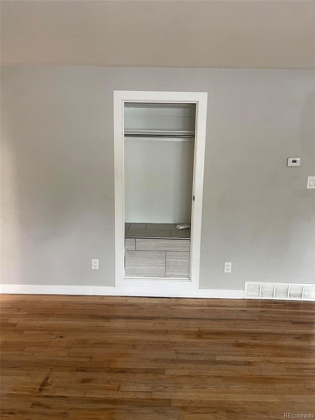 unfurnished bedroom with a closet and hardwood / wood-style floors