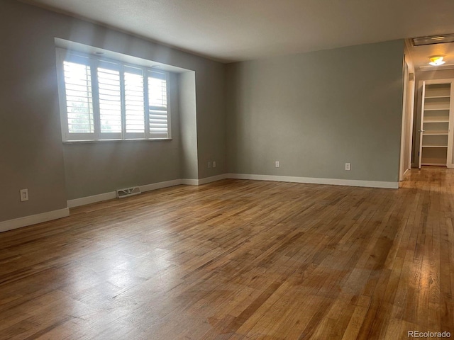 unfurnished room featuring hardwood / wood-style floors