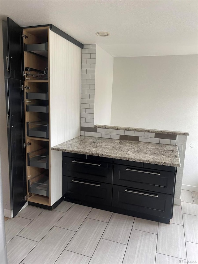 bar featuring light stone countertops