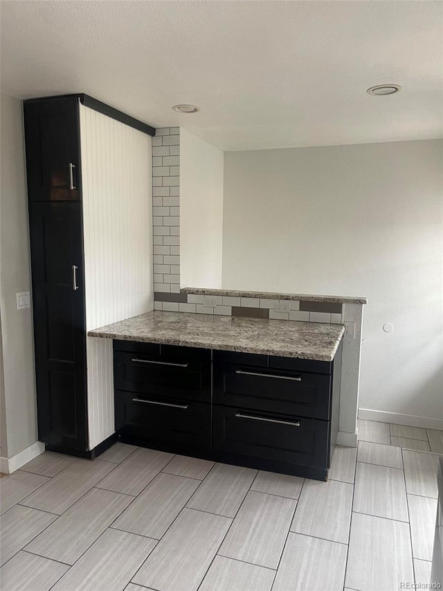 kitchen featuring light stone counters