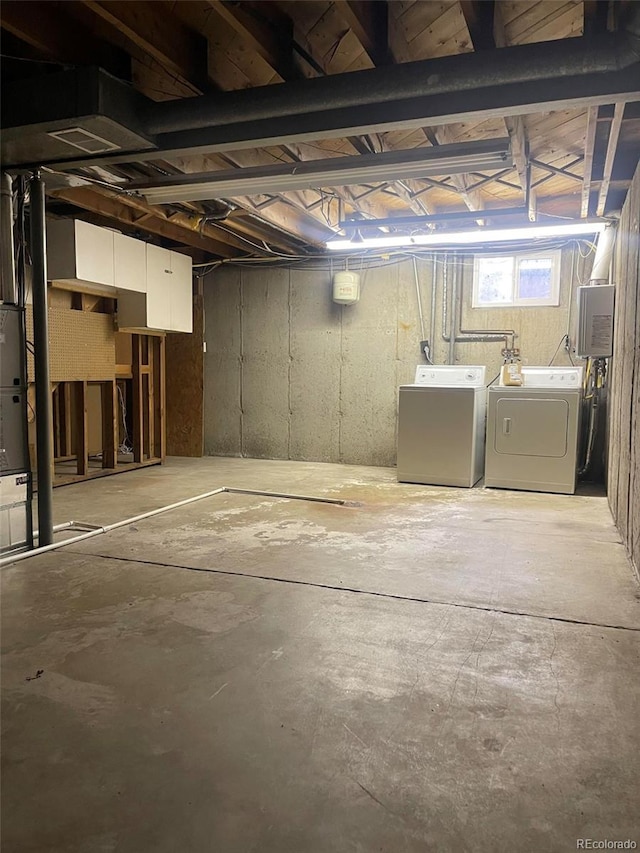 basement with separate washer and dryer and electric panel