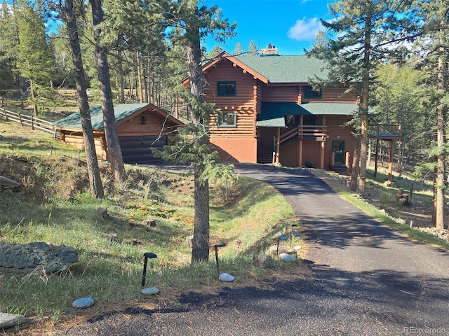 6241 Kilimanjaro Dr, Evergreen, CO 80439 - view of front of property with a shingled roof, a chimney, and log exterior