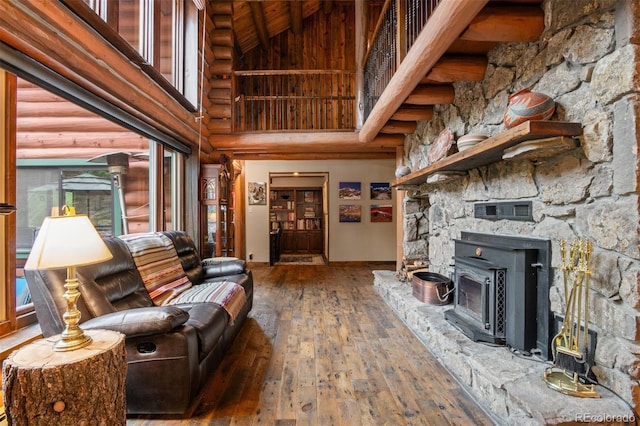 6241 Kilimanjaro Dr, Evergreen, CO 80439 - living area with high vaulted ceiling, wood-type flooring, rustic walls, baseboards, and wood ceiling