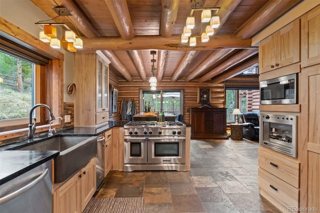 6241 Kilimanjaro Dr, Evergreen, CO 80439 - kitchen with stainless steel appliances, beam ceiling, a healthy amount of sunlight, log walls, and wood ceiling