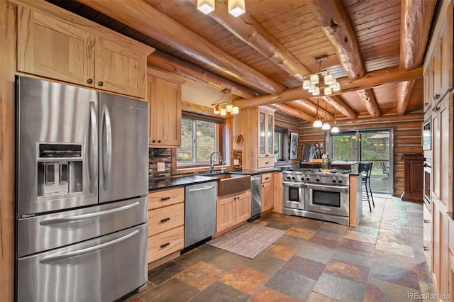6241 Kilimanjaro Dr, Evergreen, CO 80439 - kitchen featuring stainless steel appliances, a chandelier, a sink, light brown cabinets, and stone tile flooring