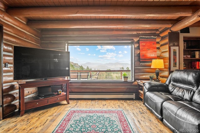 6241 Kilimanjaro Dr, Evergreen, CO 80439 - living area with light wood finished floors, log walls, baseboard heating, beamed ceiling, and wooden ceiling