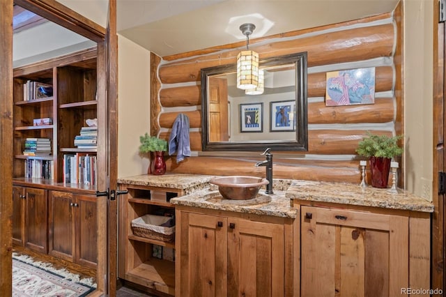 6241 Kilimanjaro Dr, Evergreen, CO 80439 - bar featuring a sink, rustic walls, and hanging light fixtures