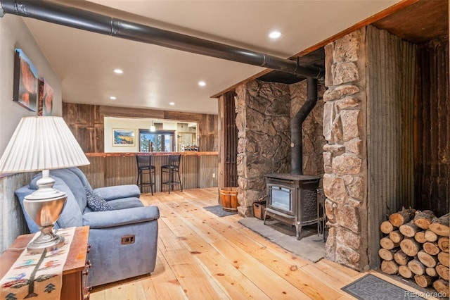 6241 Kilimanjaro Dr, Evergreen, CO 80439 - living room featuring hardwood / wood-style floors, a wood stove, recessed lighting, and bar area