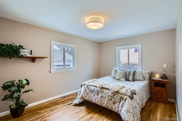 bedroom featuring baseboards and wood finished floors