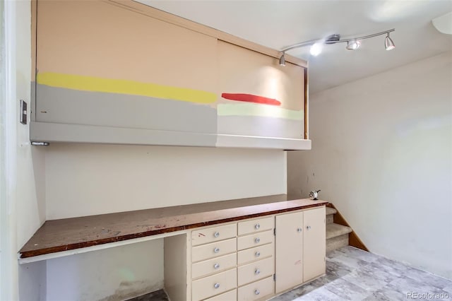 unfurnished office featuring built in desk