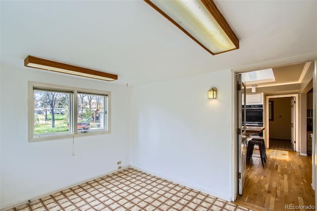 empty room featuring light floors and baseboards
