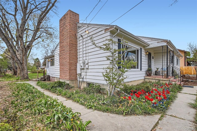 view of side of home featuring a chimney