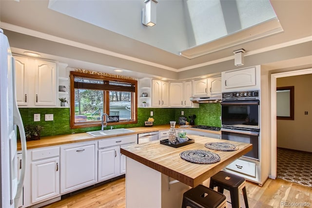 kitchen featuring a sink, dobule oven black, open shelves, and wooden counters