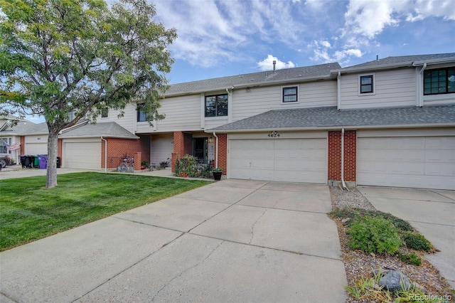 view of property with a front lawn and a garage