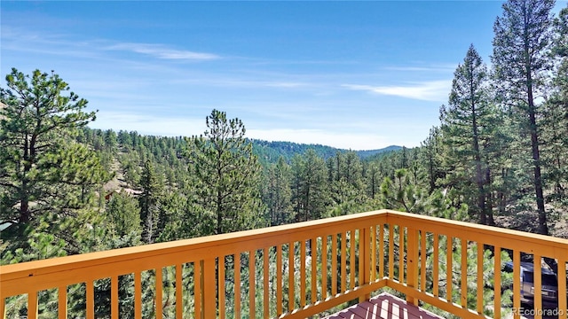 1269 Roland Dr, Bailey, CO 80421 - wooden terrace with a wooded view