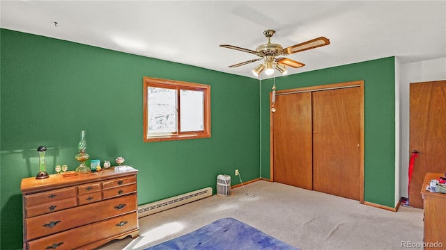 1269 Roland Dr, Bailey, CO 80421 - unfurnished bedroom with a baseboard radiator, carpet flooring, a closet, baseboards, and a ceiling fan