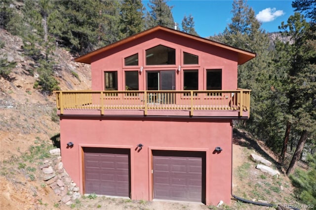 1269 Roland Dr, Bailey, CO 80421 - view of front facade with stucco siding, an attached garage, and driveway
