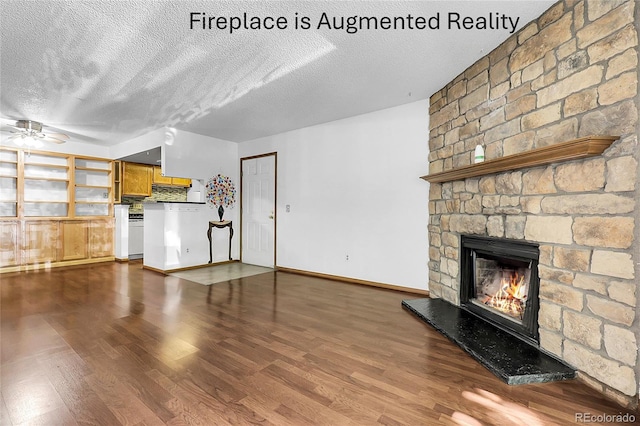 8225 Fairmount Dr Unit 102, Denver, CO 80247 - unfurnished living room featuring a stone fireplace, a ceiling fan, dark wood-type flooring, and a textured ceiling
