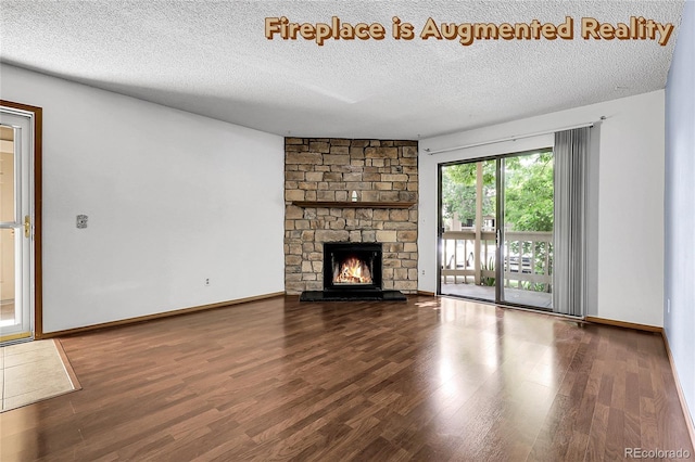 8225 Fairmount Dr Unit 102, Denver, CO 80247 - unfurnished living room featuring a textured ceiling, wood finished floors, and a stone fireplace