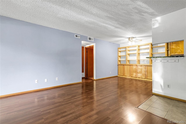 8225 Fairmount Dr Unit 102, Denver, CO 80247 - empty room with a ceiling fan, a textured ceiling, and wood finished floors