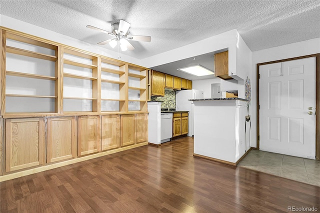 8225 Fairmount Dr Unit 102, Denver, CO 80247 - kitchen featuring white appliances, open shelves, a ceiling fan, dark wood-style flooring, and dark countertops