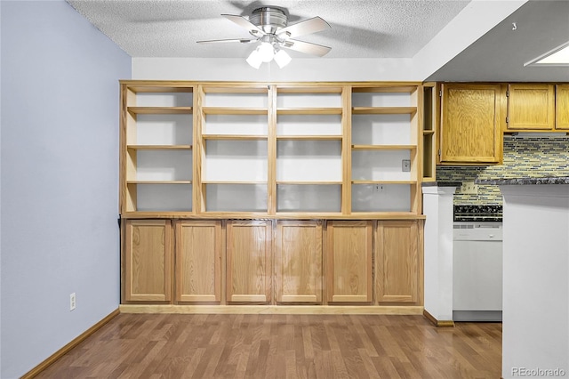 8225 Fairmount Dr Unit 102, Denver, CO 80247 - unfurnished dining area with wood finished floors, a ceiling fan, and a textured ceiling