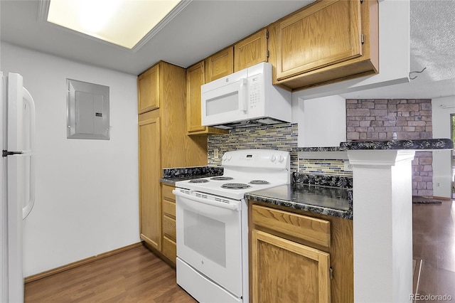 8225 Fairmount Dr Unit 102, Denver, CO 80247 - kitchen with white appliances, electric panel, dark countertops, wood finished floors, and tasteful backsplash