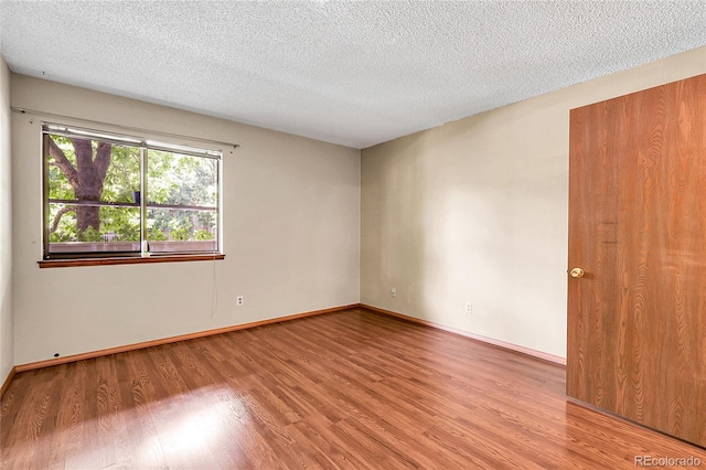 8225 Fairmount Dr Unit 102, Denver, CO 80247 - unfurnished room featuring light wood-style floors and a textured ceiling