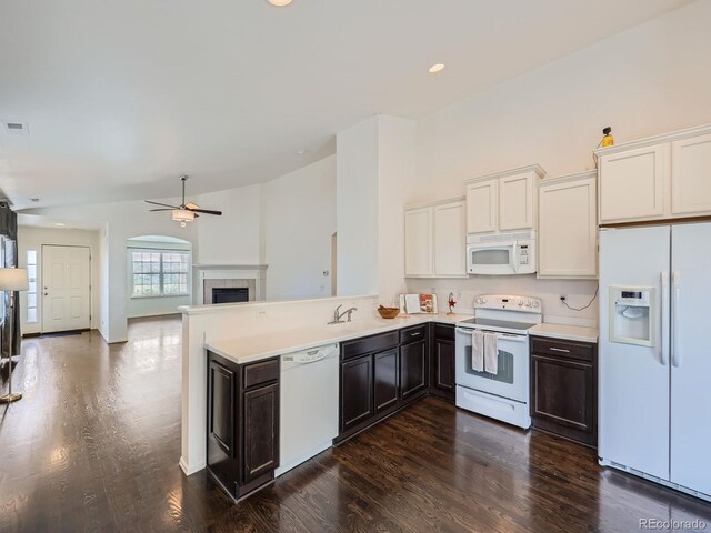 kitchen featuring white cabinetry, white appliances, kitchen peninsula, dark hardwood / wood-style flooring, and ceiling fan