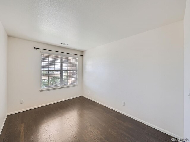 empty room with dark hardwood / wood-style floors