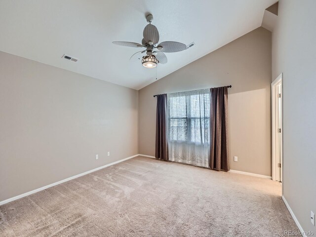 carpeted empty room featuring ceiling fan and high vaulted ceiling