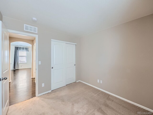 unfurnished bedroom featuring a closet and carpet floors