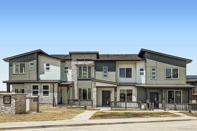14578 W 90th Ln Unit D, Arvada, CO 80547 - view of front facade featuring covered porch, a standing seam roof, and stone siding