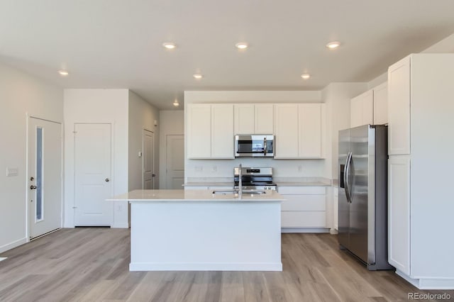 14578 W 90th Ln Unit D, Arvada, CO 80547 - kitchen with stainless steel appliances, light wood-type flooring, light countertops, white cabinetry, and recessed lighting