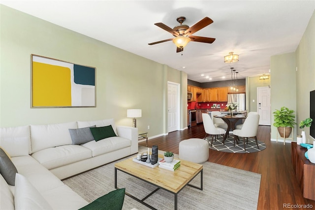 9633 E 5th Ave Unit 10208, Denver, CO 80230 - living room featuring dark wood-type flooring, a ceiling fan, and baseboards