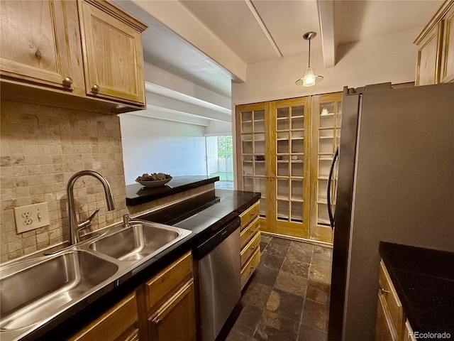 1888 S Jackson St Unit 603, Denver, CO 80210 - kitchen with appliances with stainless steel finishes, dark countertops, backsplash, dark stone finish flooring, and light brown cabinetry