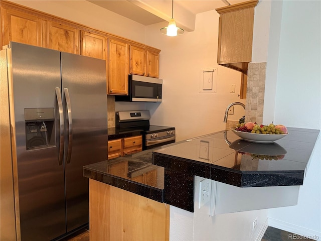 1888 S Jackson St Unit 603, Denver, CO 80210 - kitchen featuring stainless steel appliances, dark countertops, brown cabinetry, and a peninsula