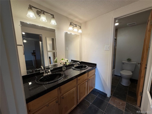 1888 S Jackson St Unit 603, Denver, CO 80210 - full bath with double vanity, a textured wall, a textured ceiling, and a shower