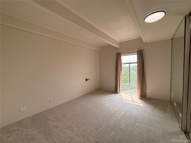 1888 S Jackson St Unit 603, Denver, CO 80210 - carpeted spare room featuring beam ceiling